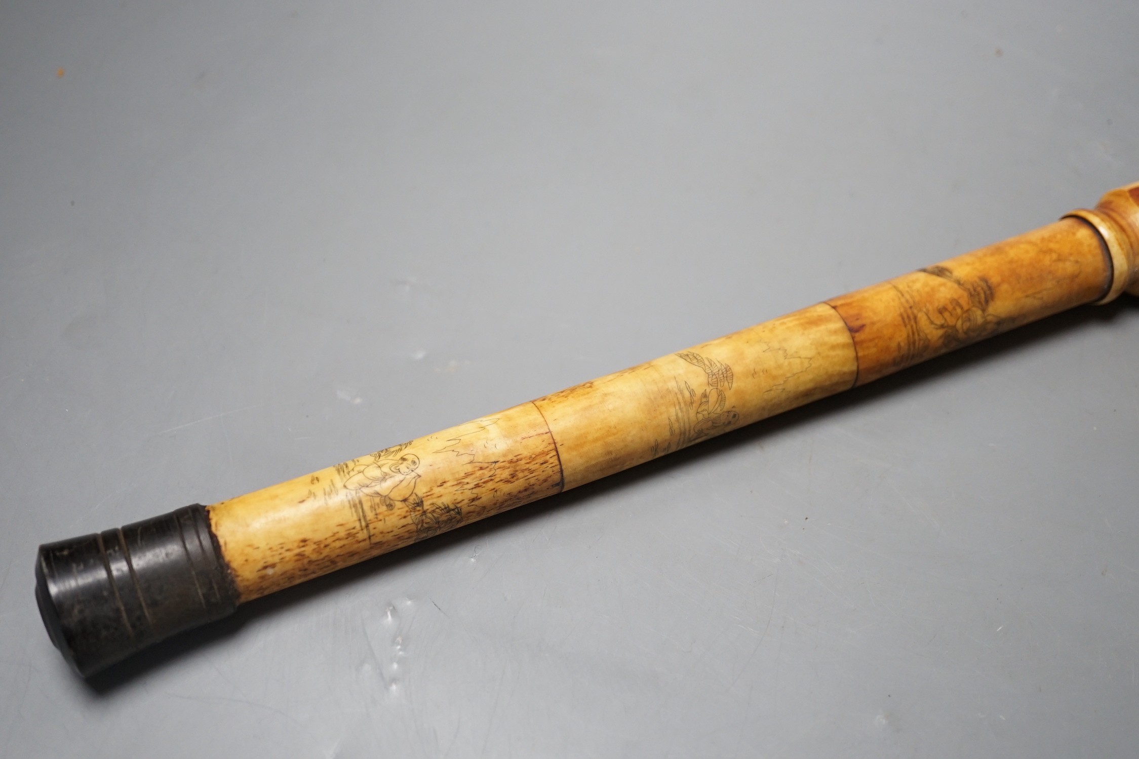 A Chinese bone opium pipe with figural decoration, 46cm wide